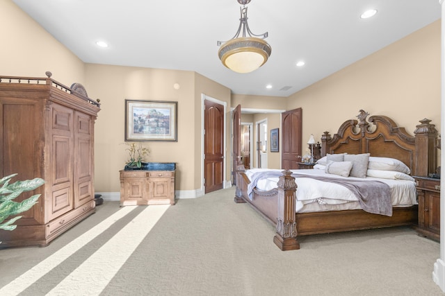 bedroom with light colored carpet, recessed lighting, and baseboards
