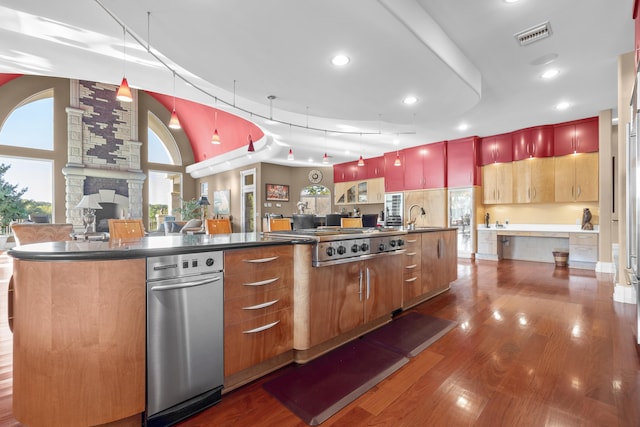 kitchen with dark wood-style flooring, dark countertops, pendant lighting, and recessed lighting