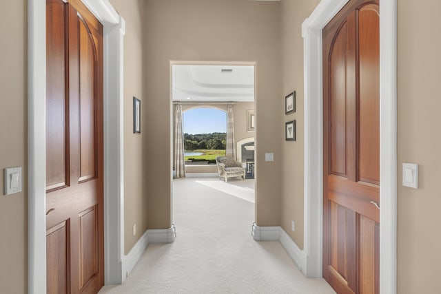 entrance foyer with light colored carpet and baseboards