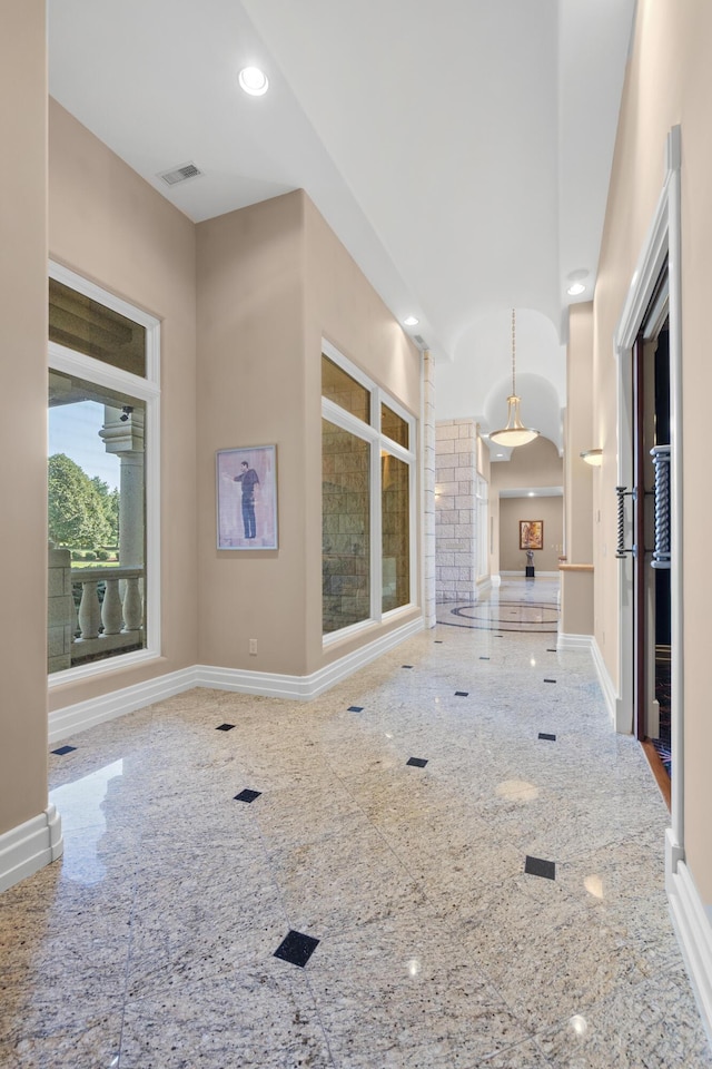 unfurnished living room featuring baseboards and recessed lighting