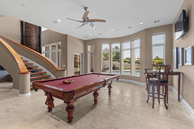 game room featuring baseboards, healthy amount of natural light, stone tile floors, ceiling fan, and recessed lighting