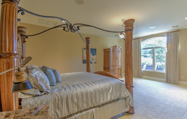 bedroom with carpet, baseboards, and decorative columns