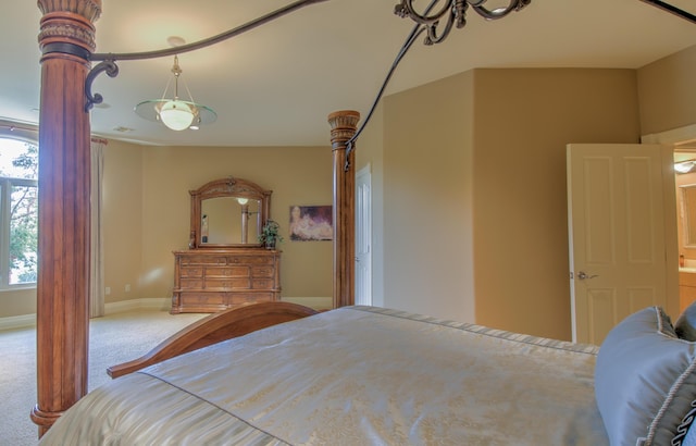 carpeted bedroom with multiple windows and baseboards