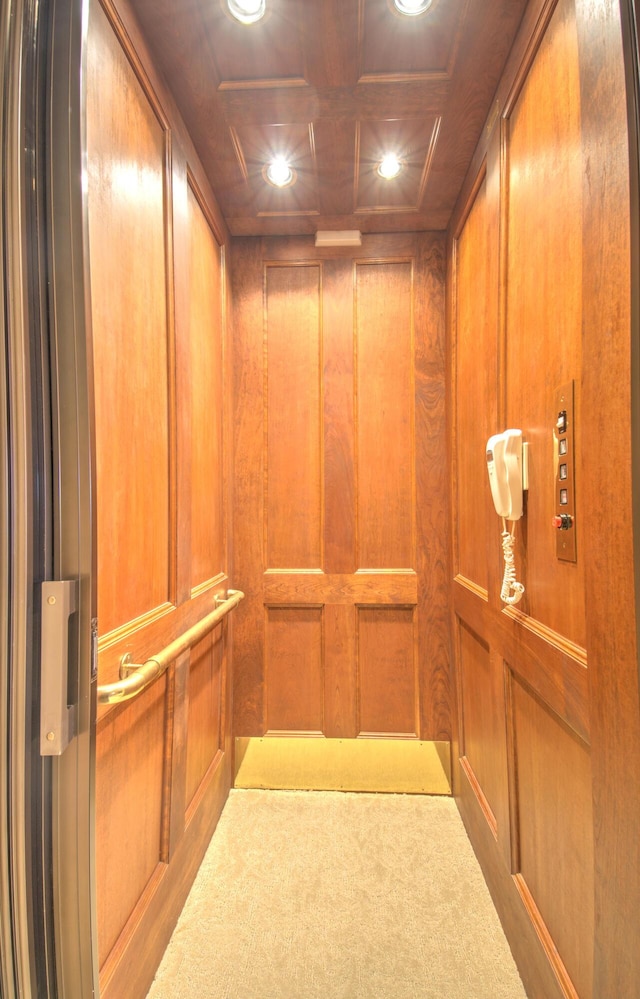 elevator with recessed lighting, carpet flooring, and wood walls