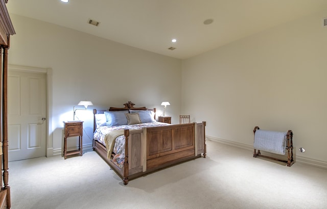bedroom featuring light carpet, recessed lighting, and baseboards