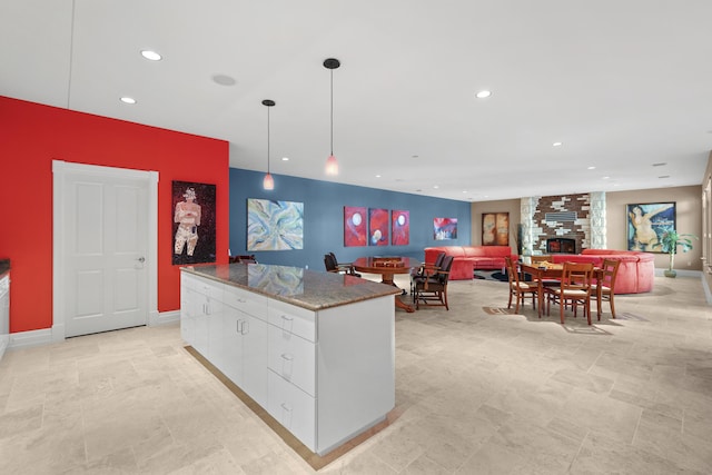 kitchen with white cabinets, a center island, recessed lighting, hanging light fixtures, and modern cabinets