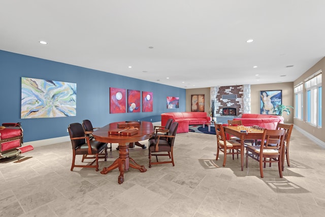 dining space featuring baseboards, recessed lighting, and a fireplace