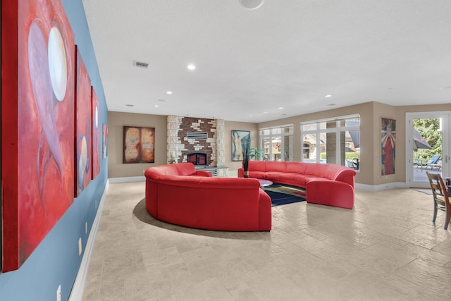living room with baseboards, recessed lighting, and a fireplace