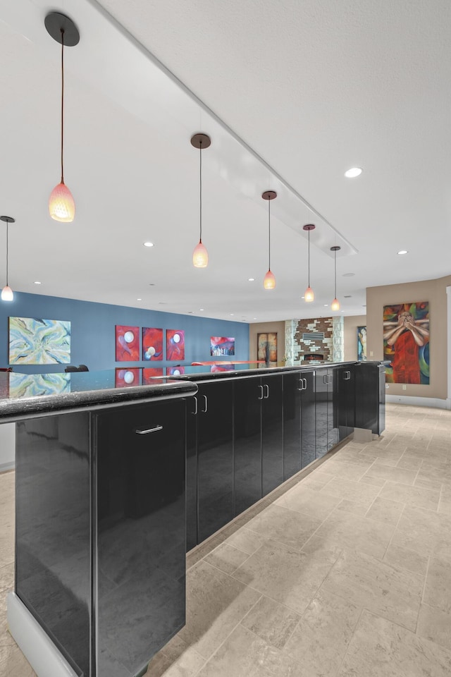 kitchen featuring dark cabinetry, recessed lighting, modern cabinets, decorative light fixtures, and dark countertops