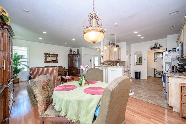 dining room featuring recessed lighting and light wood-style flooring