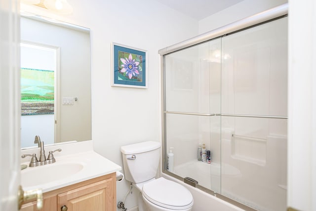 full bathroom with vanity, toilet, and bath / shower combo with glass door