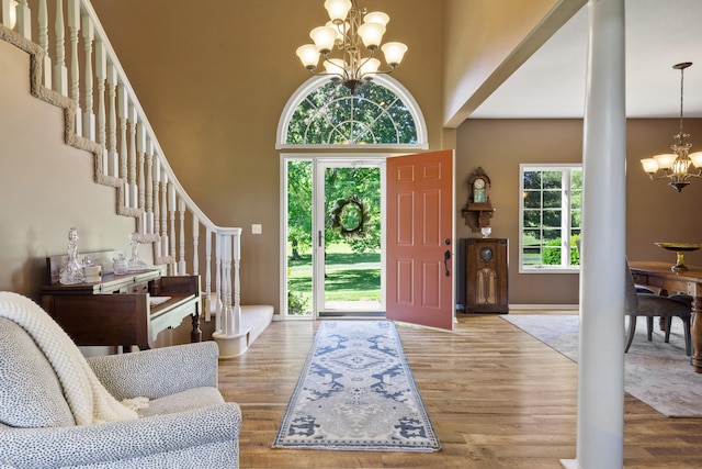 4700 E Deer Noll Rd, Columbia, MO 65201 - entryway with a chandelier, a high ceiling, wood finished floors, and stairs