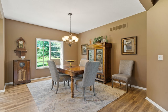 4700 E Deer Noll Rd, Columbia, MO 65201 - dining room featuring light wood finished floors, a chandelier, and baseboards