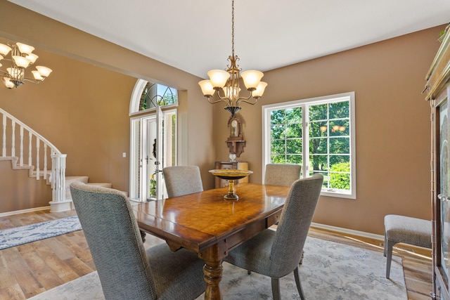 4700 E Deer Noll Rd, Columbia, MO 65201 - dining space featuring a chandelier, light wood-type flooring, stairs, and baseboards
