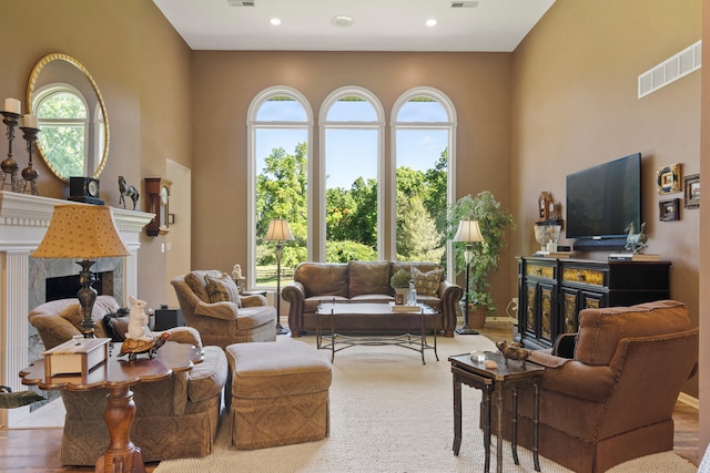 4700 E Deer Noll Rd, Columbia, MO 65201 - living room featuring a high end fireplace, a high ceiling, and recessed lighting