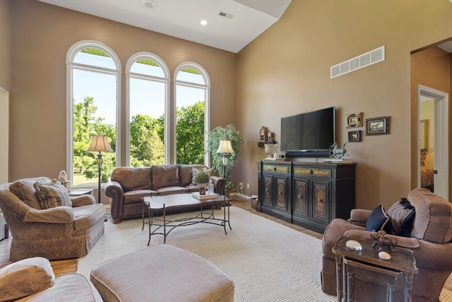 4700 E Deer Noll Rd, Columbia, MO 65201 - living room with a towering ceiling, plenty of natural light, recessed lighting, wood finished floors, and baseboards