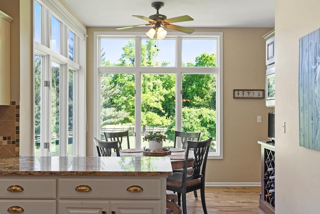 4700 E Deer Noll Rd, Columbia, MO 65201 - dining area featuring ceiling fan, baseboards, and light wood-style floors