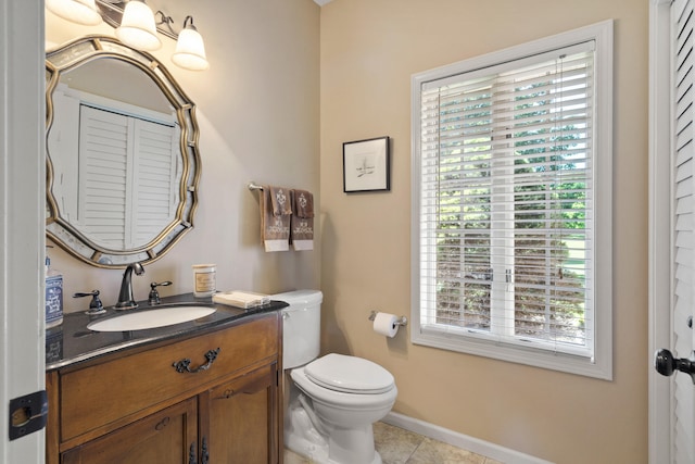 4700 E Deer Noll Rd, Columbia, MO 65201 - half bathroom with healthy amount of natural light, vanity, toilet, and tile patterned floors