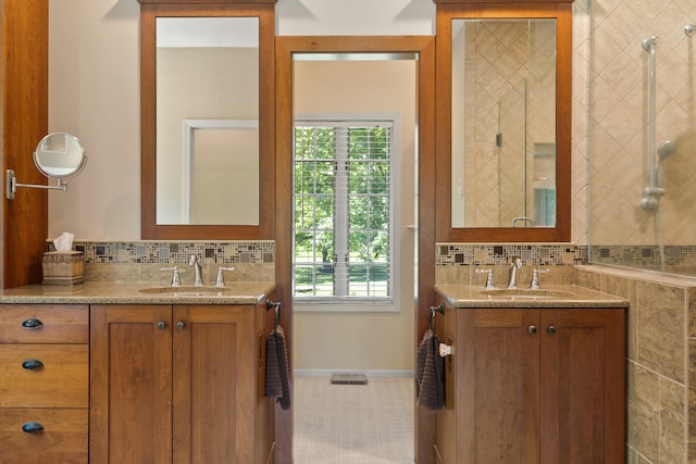 4700 E Deer Noll Rd, Columbia, MO 65201 - bathroom featuring decorative backsplash, two vanities, tile patterned floors, and baseboards