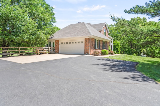 4700 E Deer Noll Rd, Columbia, MO 65201 - view of front of home with asphalt driveway, a garage, brick siding, and a shingled roof