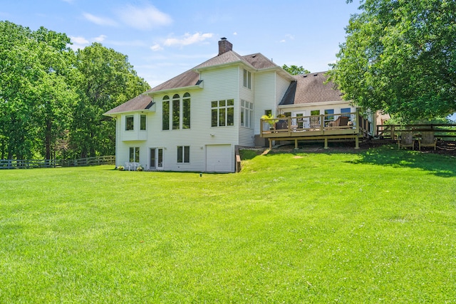 4700 E Deer Noll Rd, Columbia, MO 65201 - back of property featuring a wooden deck, a chimney, a shingled roof, and an attached garage