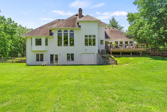 4700 E Deer Noll Rd, Columbia, MO 65201 - rear view of property with a deck, a chimney, an attached garage, roof with shingles, and central air condition unit