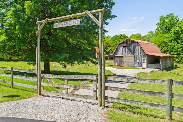 4700 E Deer Noll Rd, Columbia, MO 65201 - gate with an outdoor structure, a barn, and an exterior structure