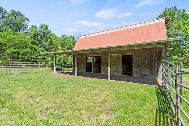 4700 E Deer Noll Rd, Columbia, MO 65201 - back of property featuring an exterior structure, metal roof, and an outbuilding
