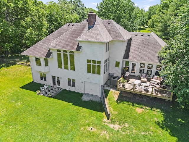 4700 E Deer Noll Rd, Columbia, MO 65201 - back of property featuring a garage, a deck, a chimney, roof with shingles, and an outdoor hangout area