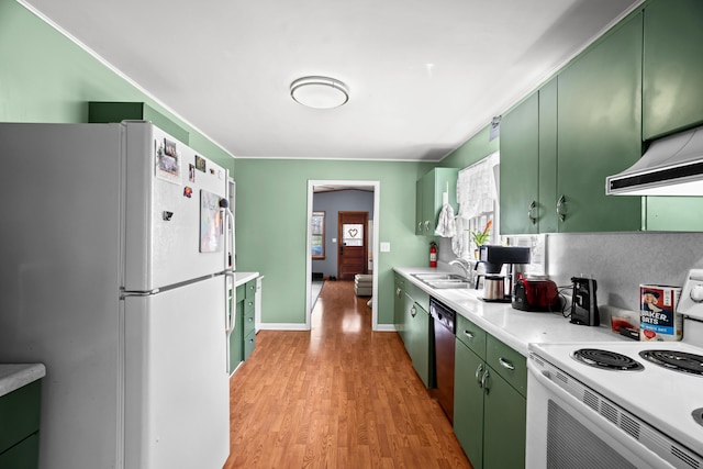 kitchen featuring green cabinets, white appliances, exhaust hood, light countertops, and light wood-style floors