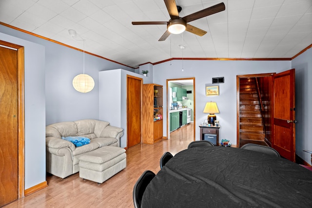 bedroom featuring crown molding, wood finished floors, and ceiling fan