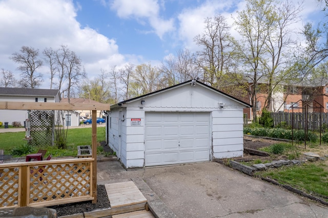 detached garage with driveway and fence