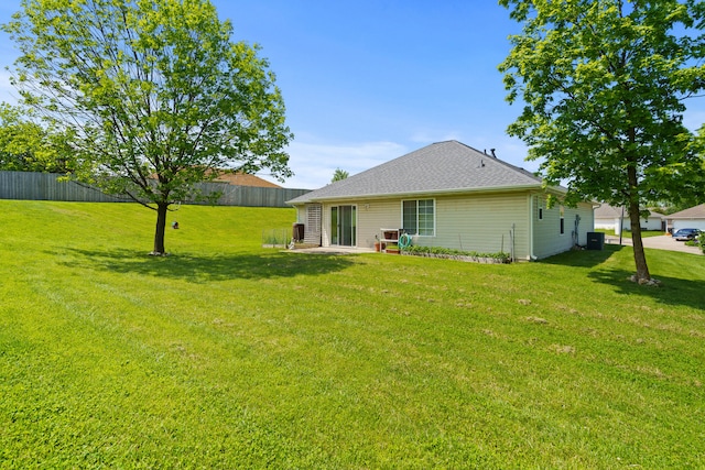 rear view of property with roof with shingles, central AC, and a patio