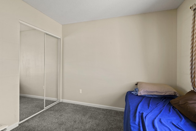 bedroom featuring carpet, a closet, and baseboards