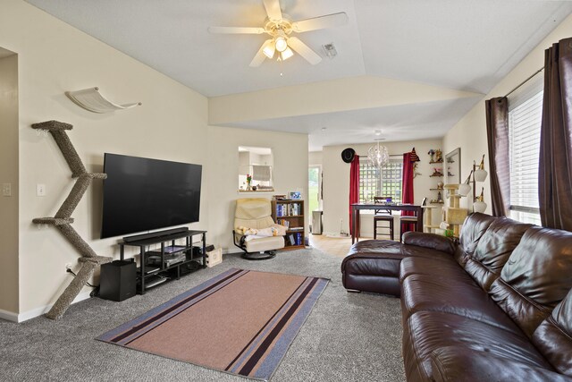 carpeted living room with plenty of natural light, ceiling fan, vaulted ceiling, and baseboards