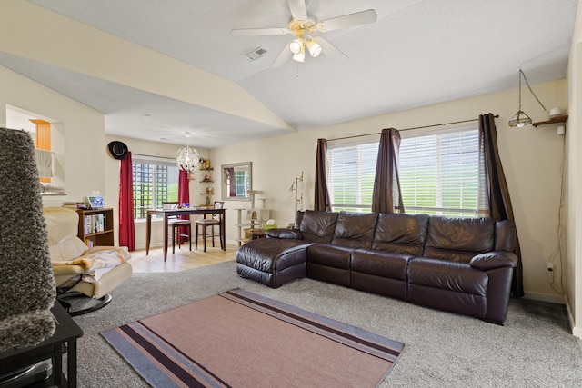 living room with carpet, vaulted ceiling, a ceiling fan, a chandelier, and baseboards