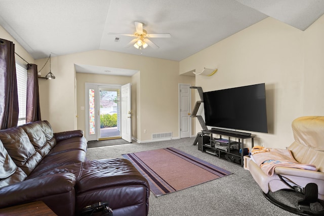 carpeted living area with lofted ceiling, ceiling fan, and baseboards