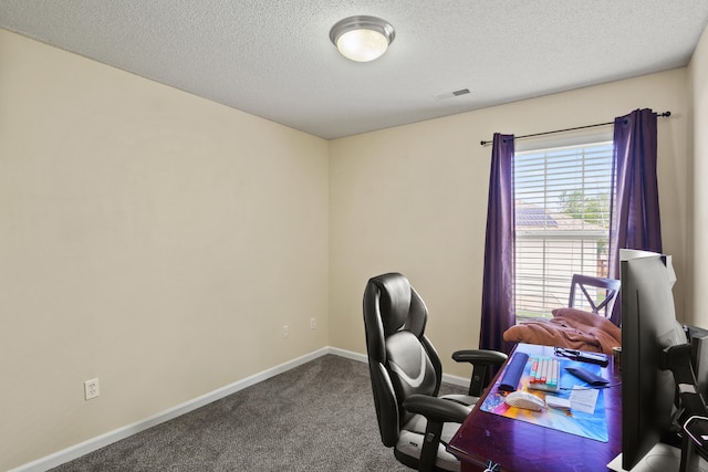 office space featuring dark carpet, a textured ceiling, and baseboards