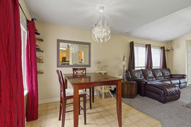 dining space featuring a chandelier and baseboards
