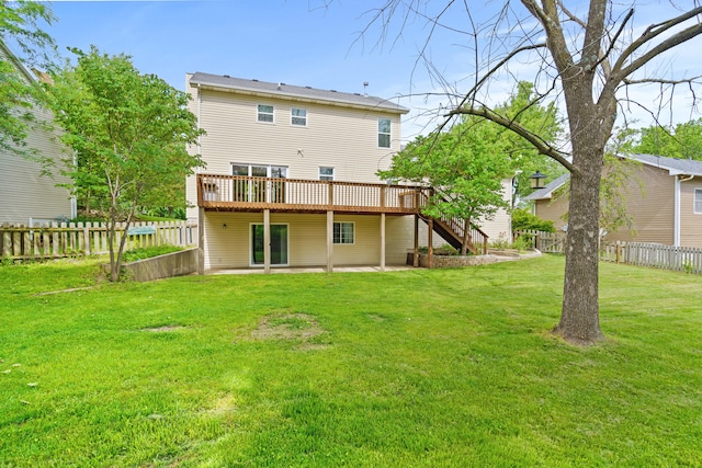 rear view of house with a wooden deck, stairs, and a patio