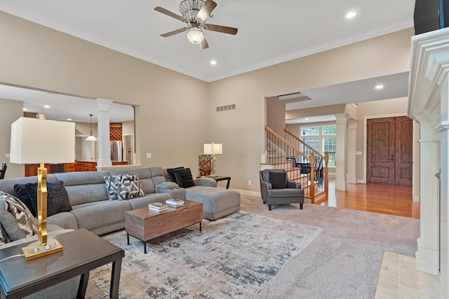 living room with decorative columns, ceiling fan, stairway, light carpet, and recessed lighting