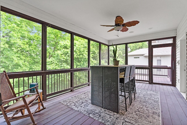 sunroom featuring ceiling fan