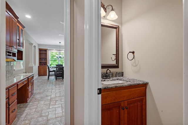 bathroom featuring vanity, recessed lighting, and stone finish floors