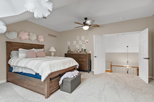 bedroom featuring carpet floors, vaulted ceiling, baseboards, and ceiling fan