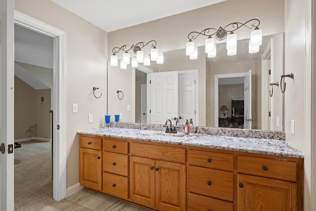 bathroom with vanity and baseboards