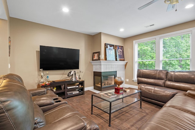 living room featuring a ceiling fan, baseboards, wood finished floors, recessed lighting, and a fireplace
