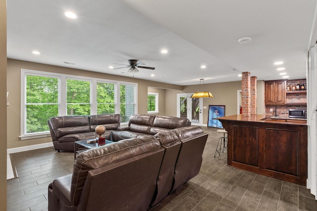 living room with baseboards, recessed lighting, ceiling fan, and wood tiled floors