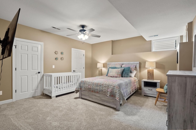 carpeted bedroom with a ceiling fan and baseboards
