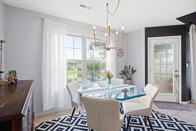 dining room with a chandelier and light tile patterned flooring
