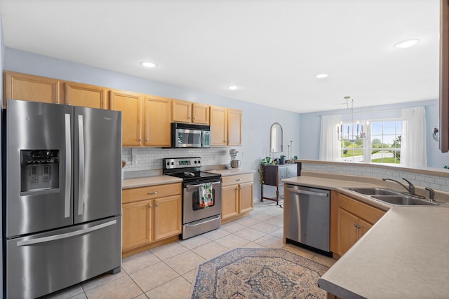 kitchen with stainless steel appliances, a sink, backsplash, light tile patterned floors, and light countertops